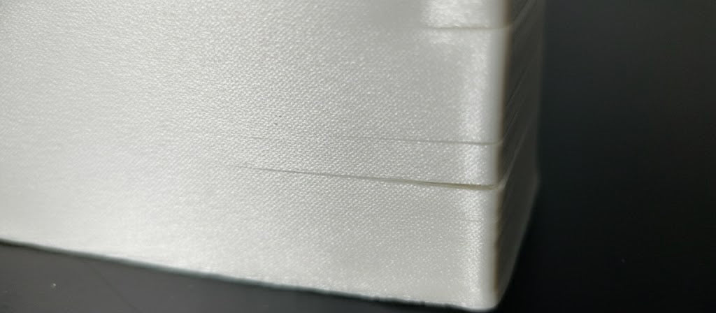 Layer delamination in FDM 3D printing showing visible cracks and separation between printed layers